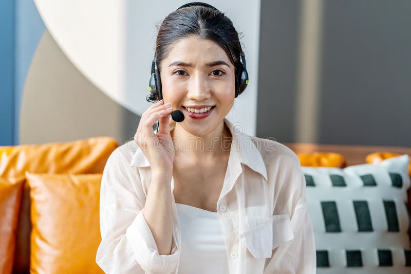 Consultant Girl Wearing Headset with Microphone Sitting on Sofa, Call