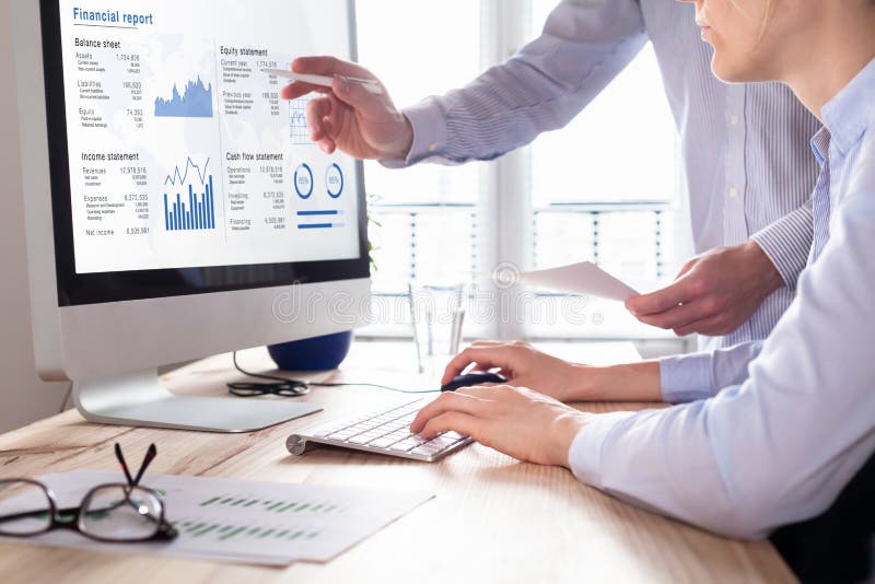 Consulting auditors auditing financial report on computer screen, business charts stock photography