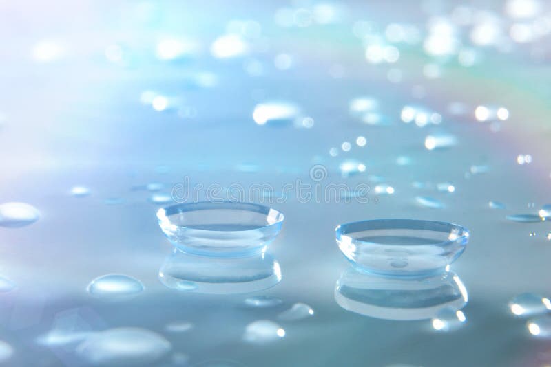 Contact lenses macro on glass with blue background royalty free stock images Contact lenses macro on glass with blue background royalty free stock images