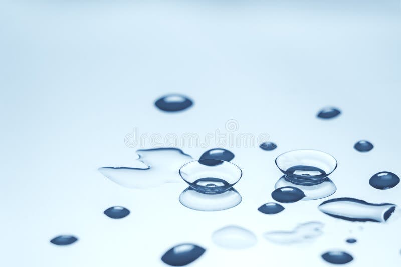 Contact lenses with water drops on reflective surface