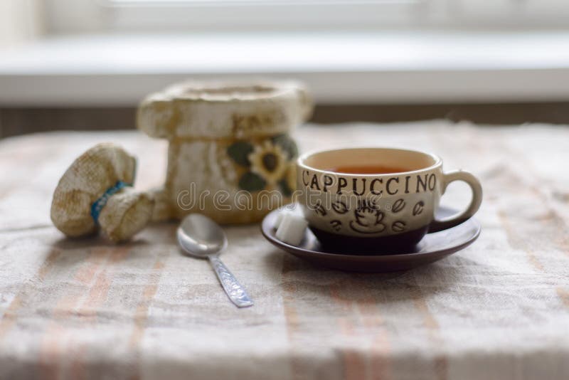 A Container for Coffee, a Cup on a Saucer with Sugar and a Teaspoon