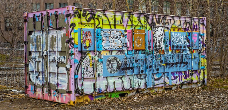 Container colorat încărcat cu graffiti lângă un șină de cale ferată din Montreal royalty free stock image