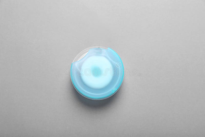 Container with Dental Floss on Grey Background, Top View Stock Image