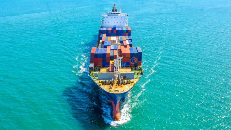 Container ship in export and import business logistics and transportation. Cargo and container box shipping to harbor by crane. stock photo