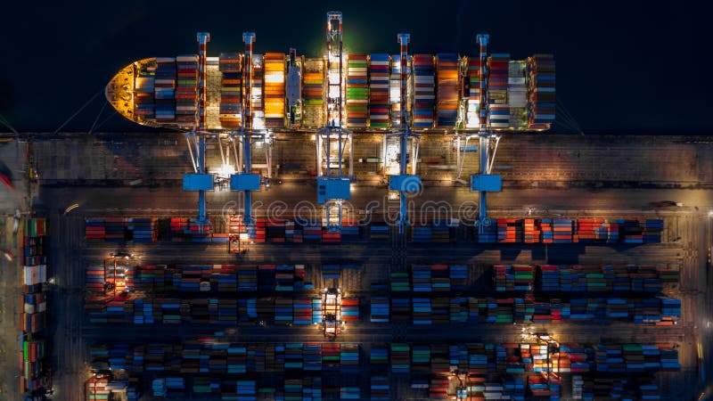 Container ship in import export business logistic at night, Aerial top view of container ship royalty free stock image