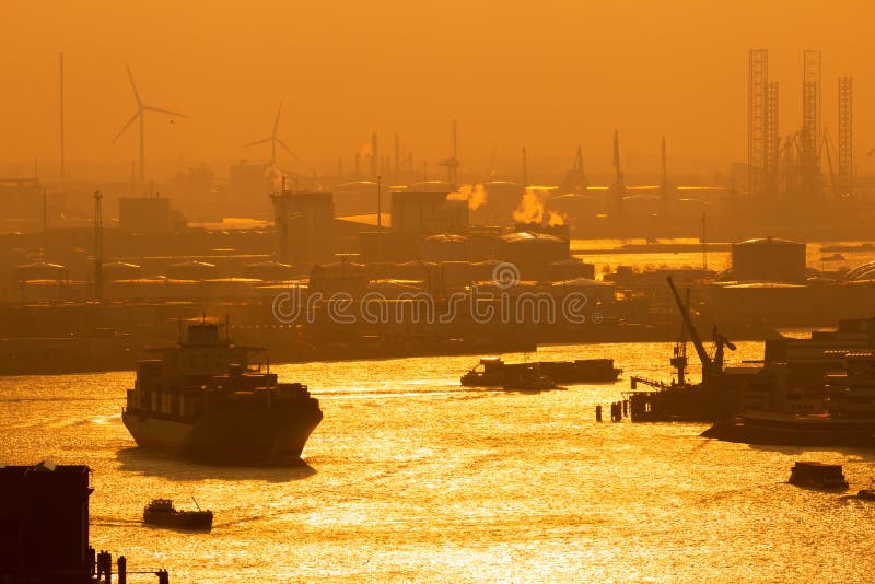 Container ship on the Meuse river in the Port of Rotterdam during sunset