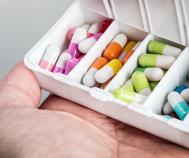 Container with various pills in different colors