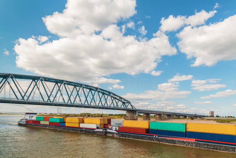 Container vessel passing a bridge on the Dutch river Waal in Nijmegen stock images Container vessel passing a bridge on the Dutch river Waal in Nijmegen stock images