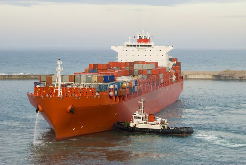 Container Vessel And A Small Tug Boat Stock Photo - Image 