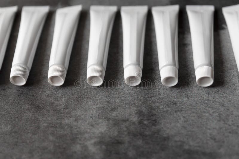 White Plastic Tubes with Dark Background Stock Photo Image of graphic