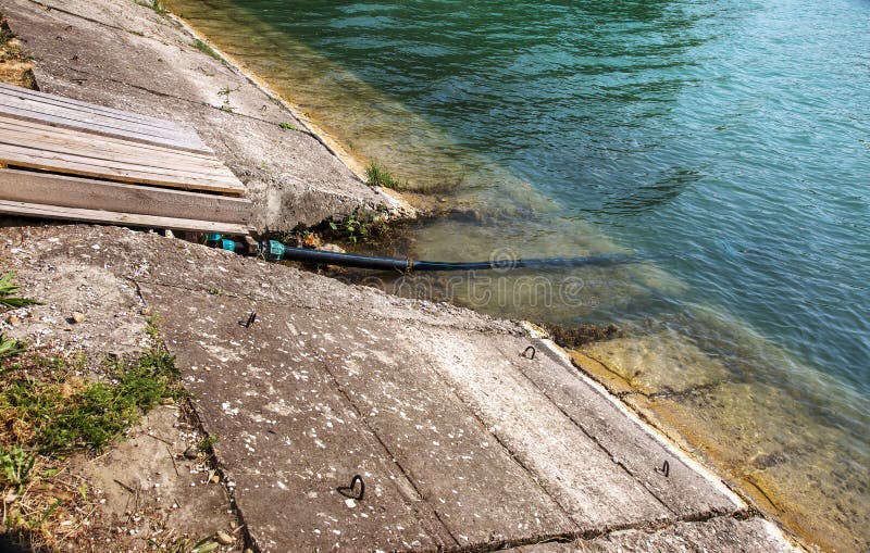Contaminated water, sewage waste is drained through pipe into sea on an unequipped beach. Pollution of environment, ecological cat stock photo