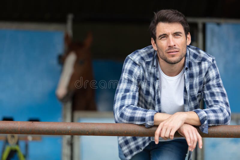 contemplative man at equestrian stables