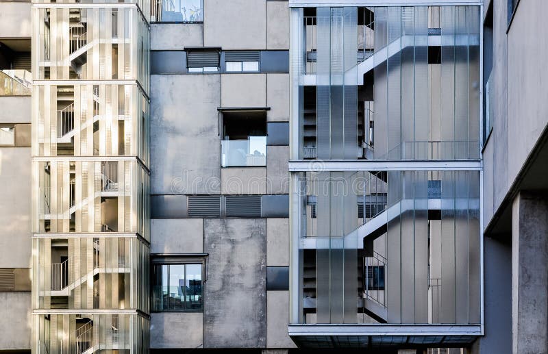 Contemporary concrete and glass building facade with sunset reflections