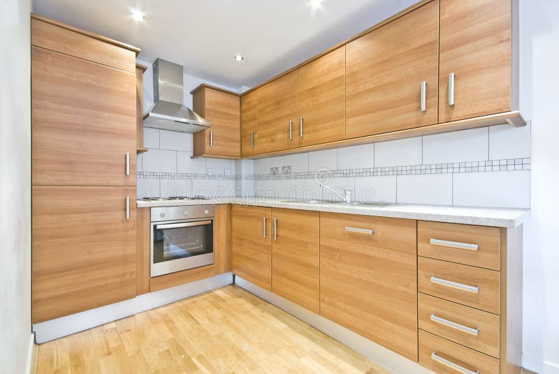 Contemporary fully fitted wooden kitchen stock photo