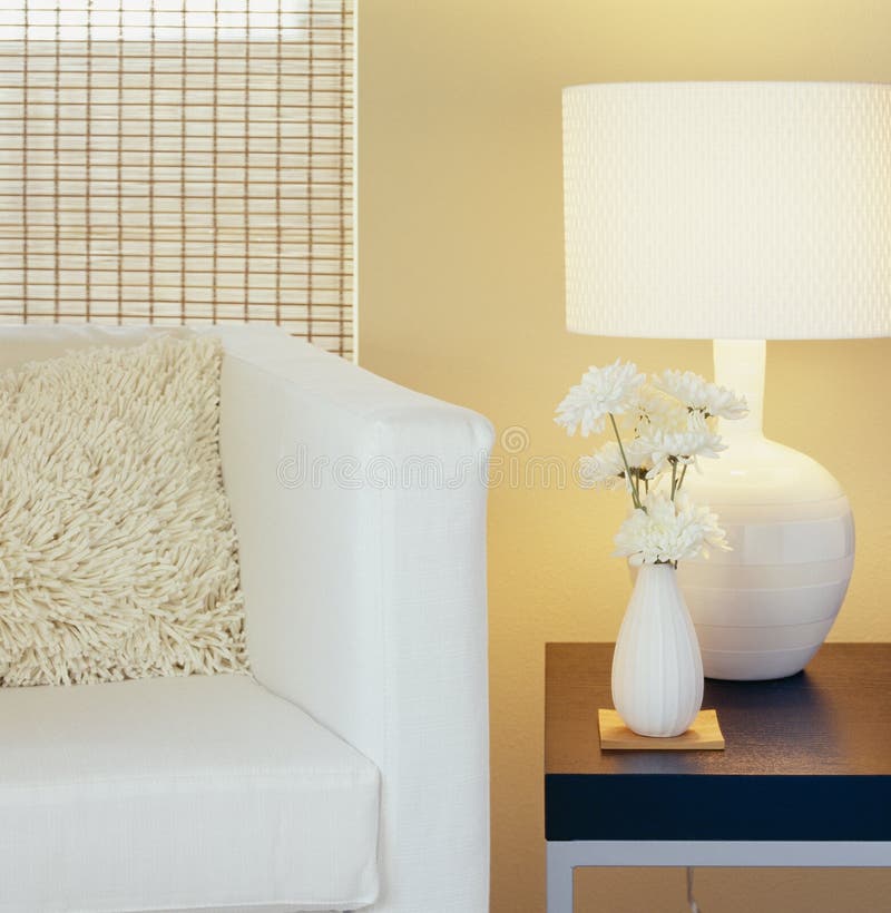 Modern home interior decor. Living room with chair, pillow, table, lamp, painted wall, window blinds and flowers in vase. stock images Modern home interior decor. Living room with chair, pillow, table, lamp, painted wall, window blinds and flowers in vase. stock images