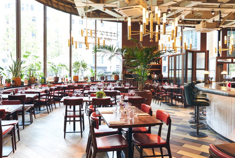 Contemporary restaurant interior with table settings royalty free stock images