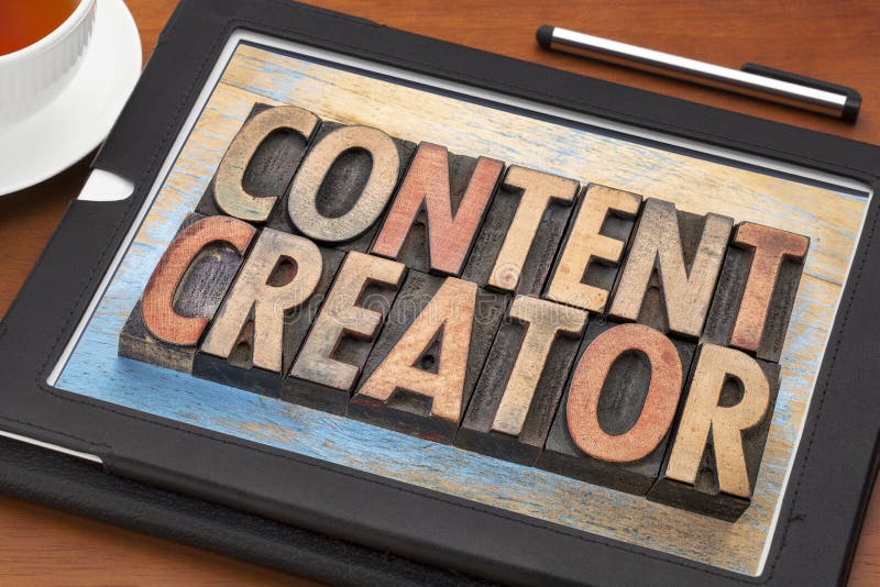 Content creator - word abstract in vintage letterpress wood type printing blocks on a digital tablet. Content creator - word abstract in vintage letterpress wood type printing blocks on a digital tablet