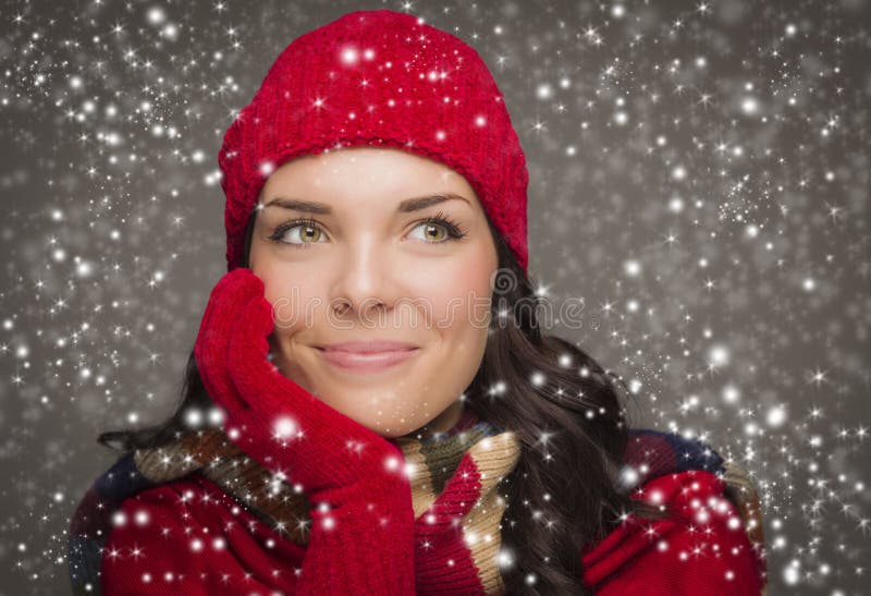 Content Mixed Race Woman Wearing Winter Hat and Gloves Enjoys Snowfall