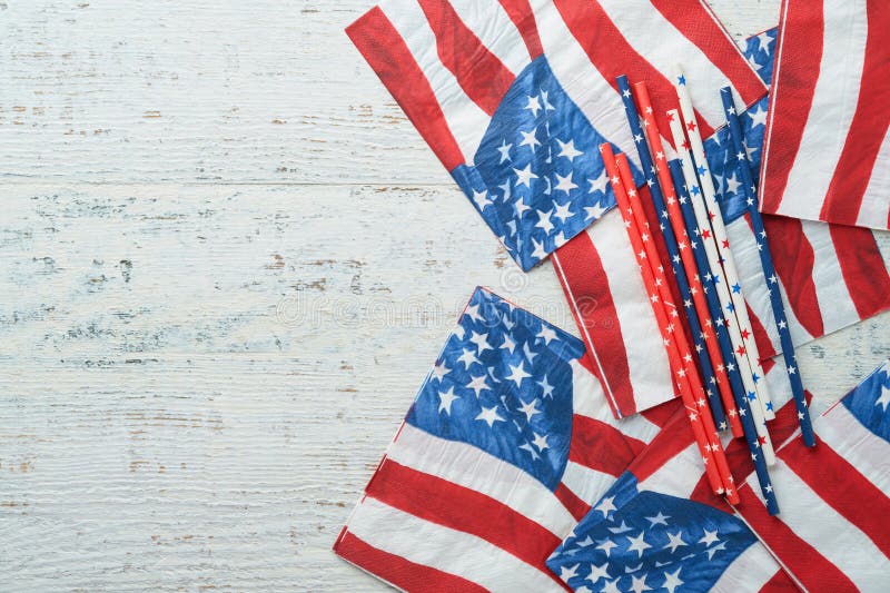 4th of July background. US flag paper napkin and picnic cocktail straws on old white table background. Happy Labor, Independence, Presidents Day. Happy picnic concept. American flag colors. Mock up. 4th of July background. US flag paper napkin and picnic cocktail straws on old white table background. Happy Labor, Independence, Presidents Day. Happy picnic concept. American flag colors. Mock up