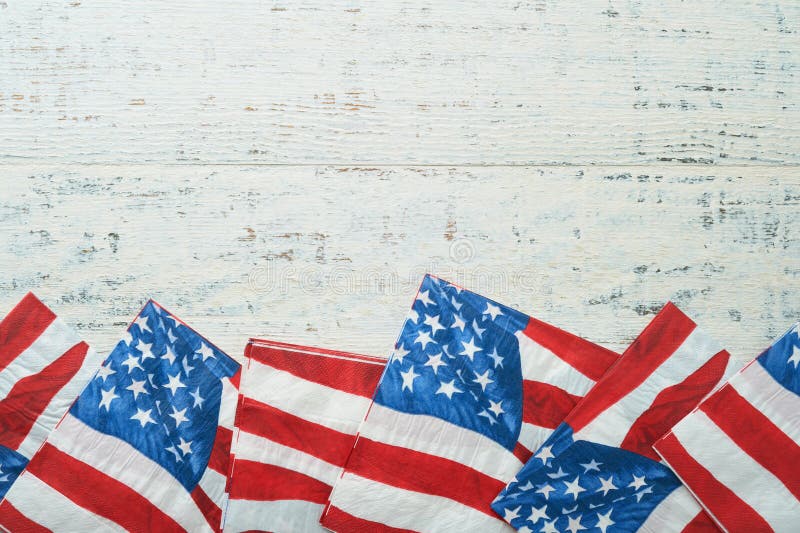 4th of July background. US flag paper napkin and picnic cocktail straws on old white table background. Happy Labor, Independence, Presidents Day. Happy picnic concept. American flag colors. Mock up. 4th of July background. US flag paper napkin and picnic cocktail straws on old white table background. Happy Labor, Independence, Presidents Day. Happy picnic concept. American flag colors. Mock up