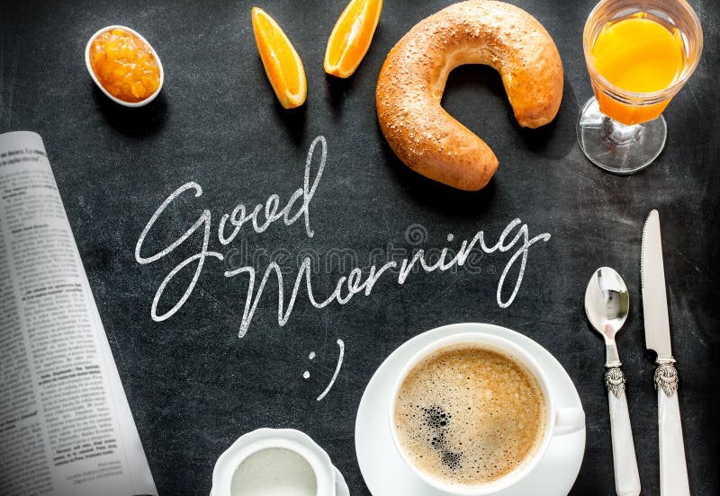 Good morning poster design with continental breakfast on black chalkboard background. Bar morning menu - coffee, orange juice, crescent roll and jam from above.