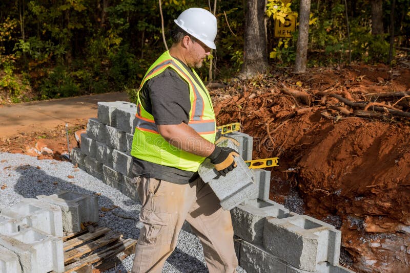 A Contractor is Constructing a Block Retaining Wall on a Construction