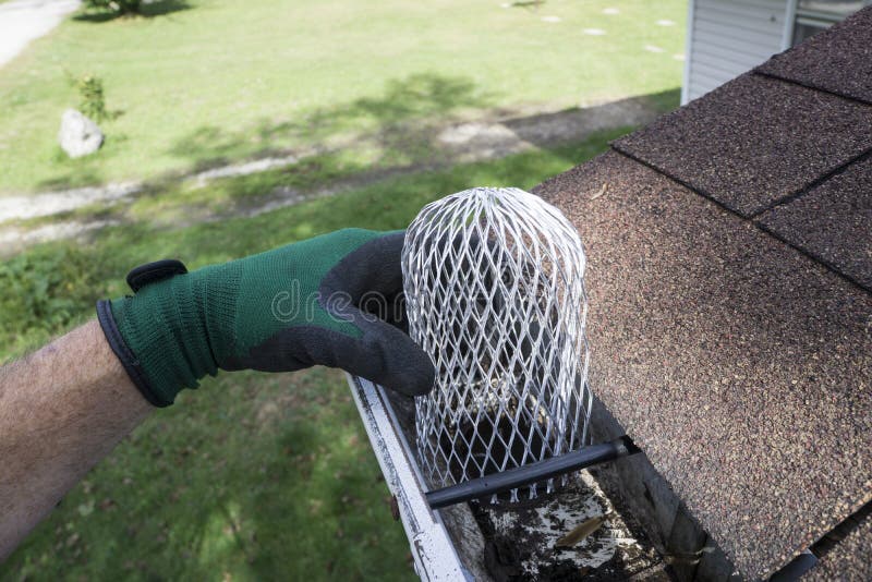 Contractor Installing A Down Spout Filter / Strainer