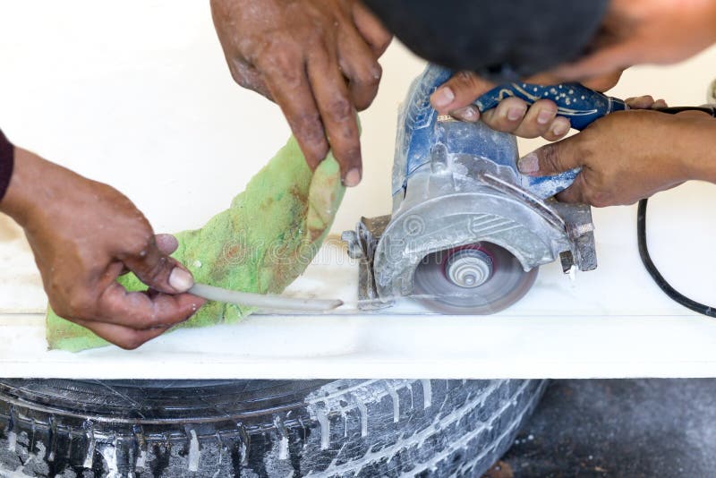 Contractor Using Circular Saw for Cutting Marble Top Stock Image