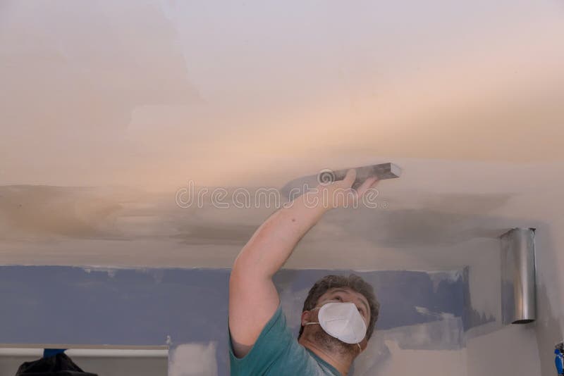 Sanding a Plasterboard Ceiling in a New Building with a Trowel Stock