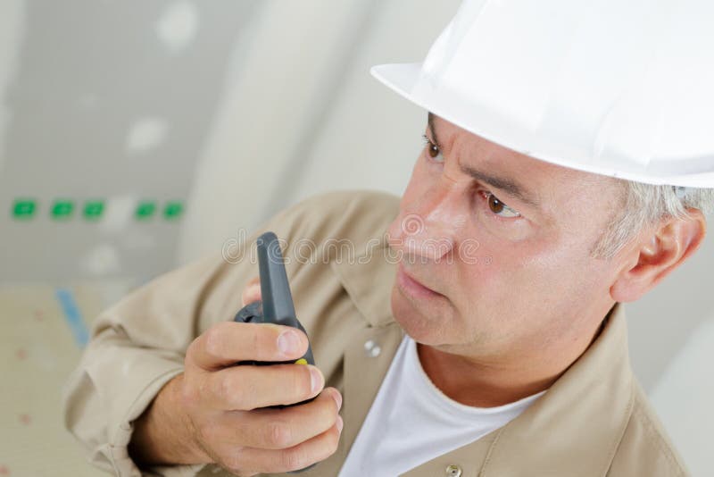 Contractor Using Walkietalkie Indoors Stock Image Image of indoors