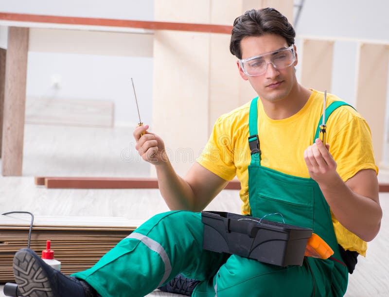 Contractor working on laminate wooden floor royalty free stock photos Contractor working on laminate wooden floor royalty free stock photos