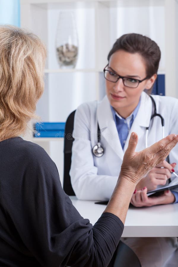 Middle aged women having a conversation with a doctor. Middle aged women having a conversation with a doctor