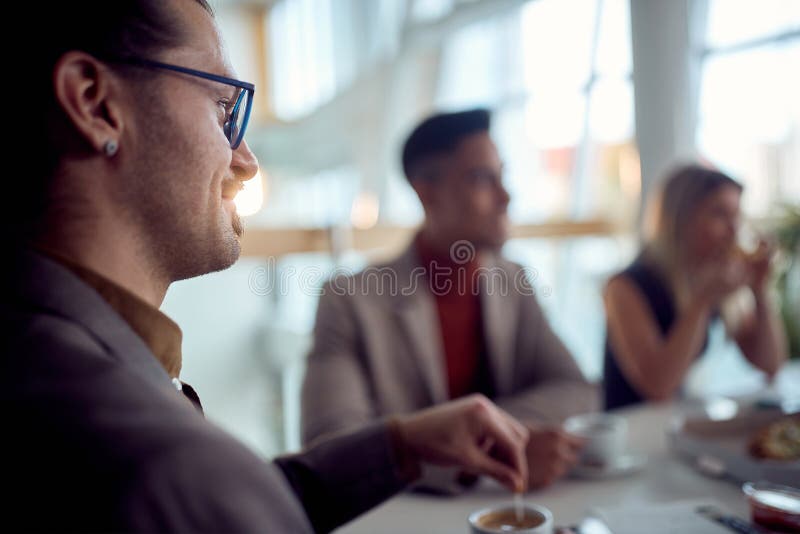 Conversation at a Business Lunch. Group of People in Room Talks Stock