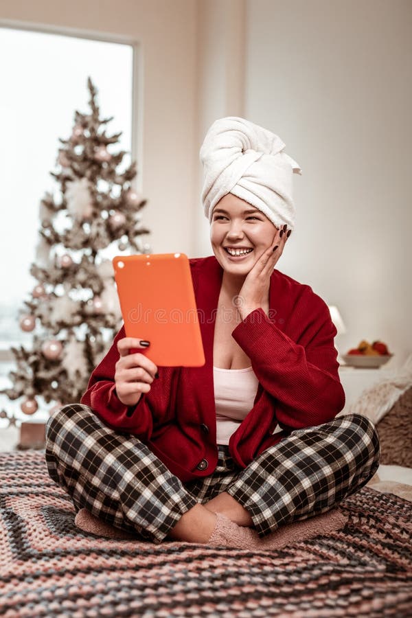 Positive laughing woman having video call and listening to funny friend royalty free stock image Positive laughing woman having video call and listening to funny friend royalty free stock image