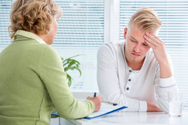 Doctor talking to her male patient at office. Doctor talking to her male patient at office