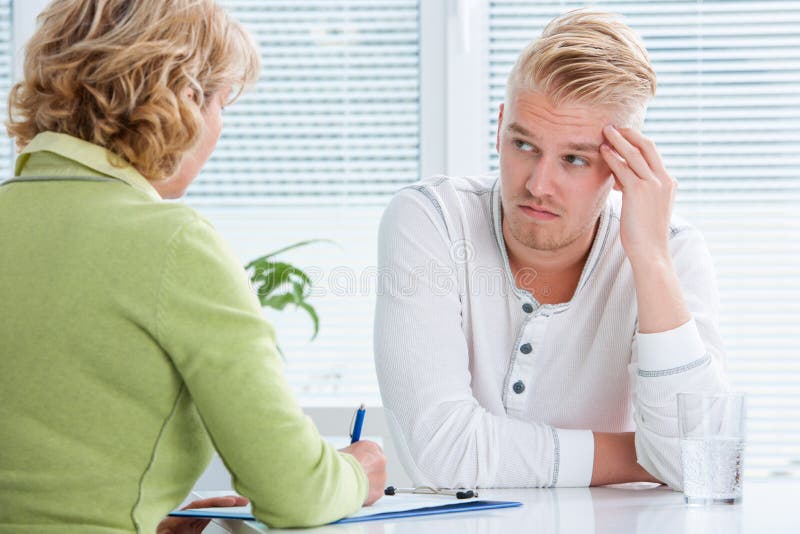 Doctor talking to her male patient at office. Doctor talking to her male patient at office