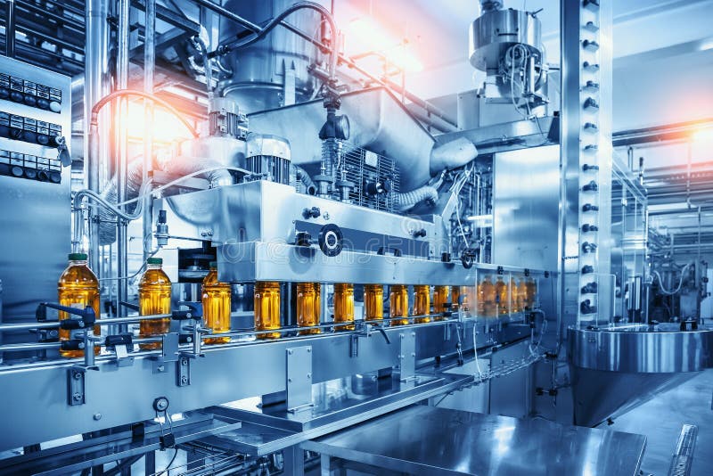 Conveyor belt with juice bottles on beverage factory interior in blue color