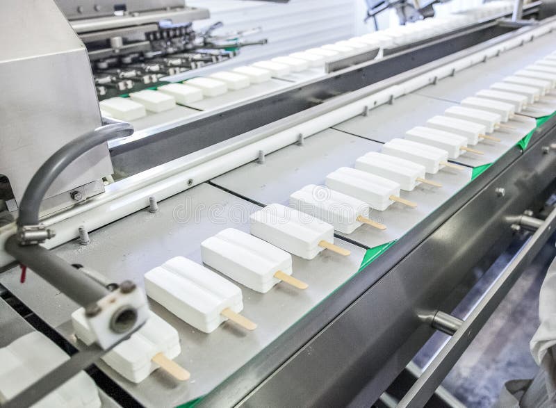 Conveyor production of stick ice-cream at factory stock photography