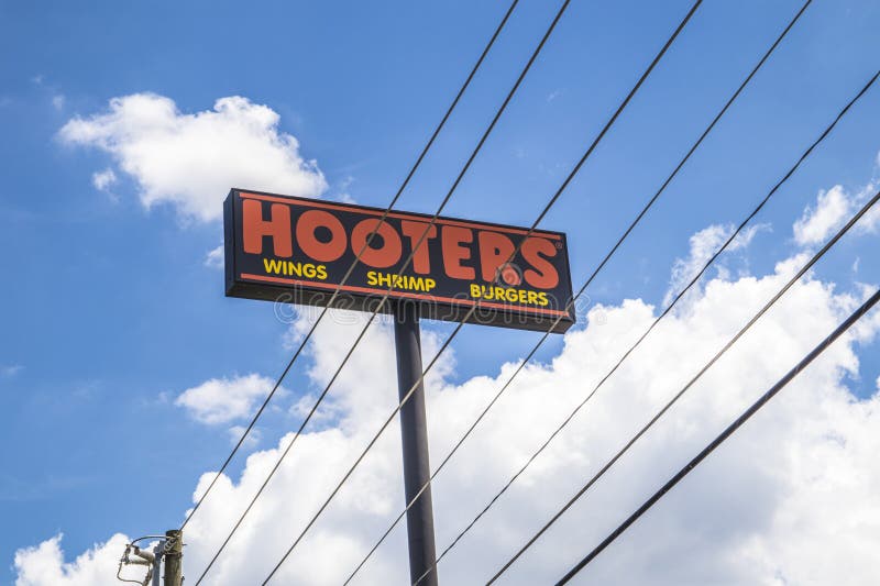 Hooters restaurant sky street sign with power lines