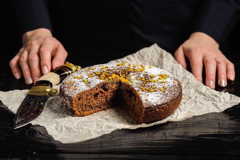 A Cook is Cutting a Chocolate Cake with a Knife Stock Image Image of