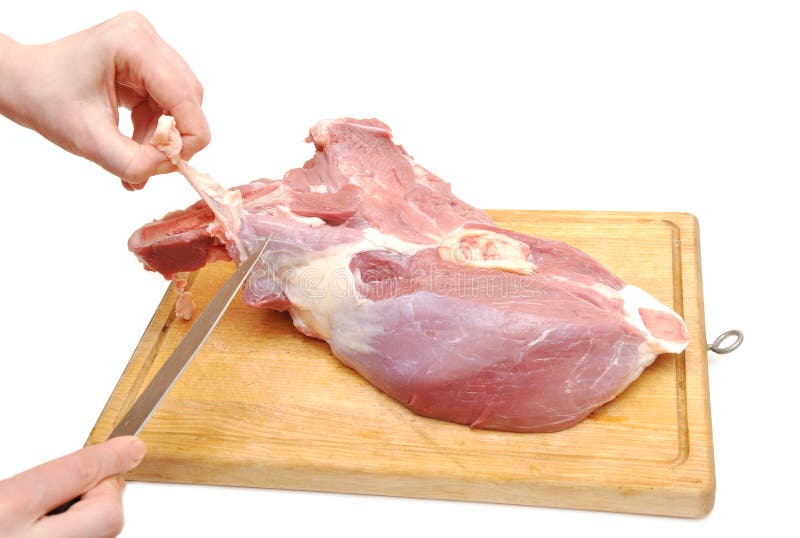 Cook in a kitchen cutting raw meat