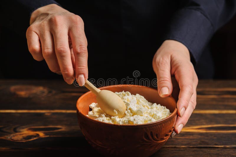 Cook prepares a dish of rustic cottage cheese royalty free stock photography
