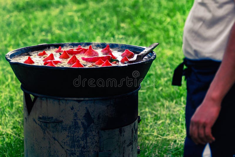Cook prepares Uzbek Pilaf with paprika royalty free stock image