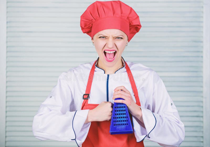 Cook in restaurant, uniform. girl in apron and hat. professional chef cooking in kitchen. angry woman loves cooking food stock photo Cook in restaurant, uniform. girl in apron and hat. professional chef cooking in kitchen. angry woman loves cooking food stock photo