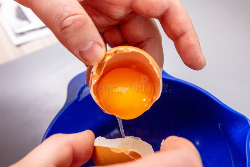 The Cook Separates the Egg Yolk from the Egg White in the Shell Stock