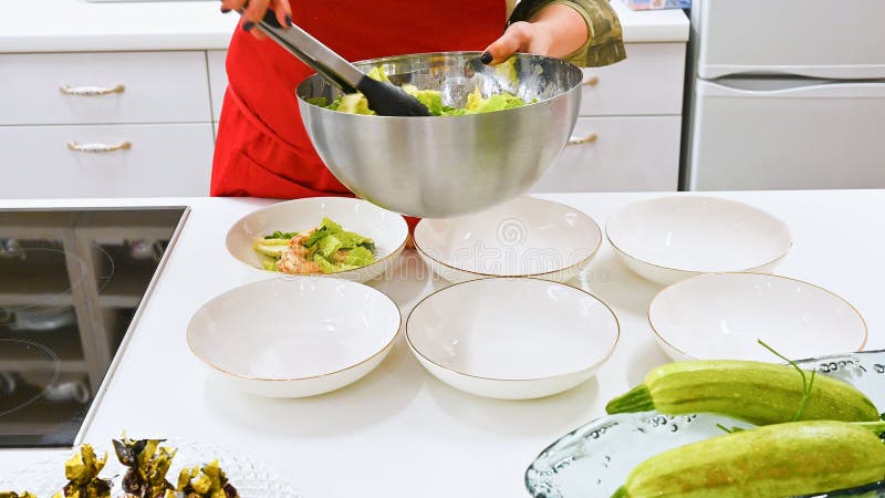 The Cook Spreads the Cooked Salad. Vegetarian Food. Cook in the Kitchen