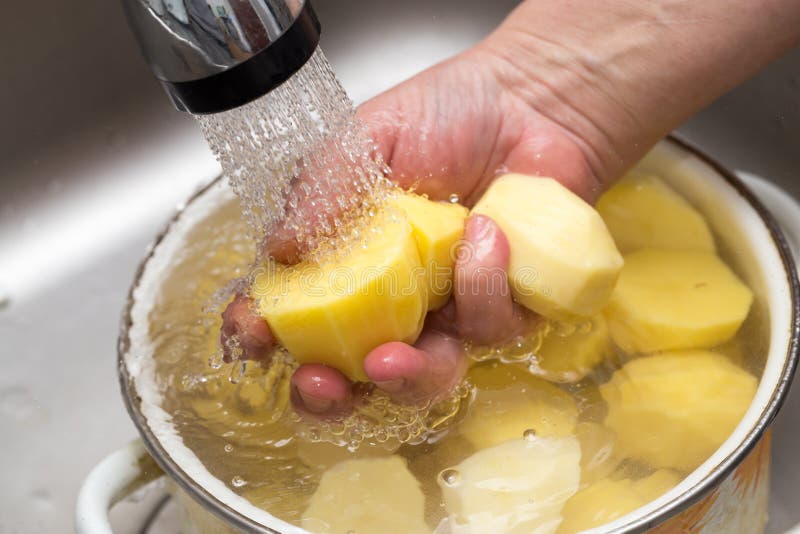 Potato in Water with Splashes on a Black Background Stock Photo Image