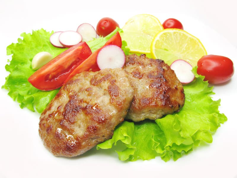 Cooked meat cutlets with vegetables stock photography