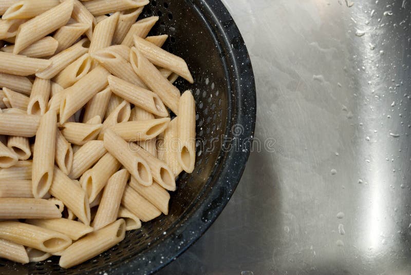 Cooked penne pasta stock image. Image of steel, colander - 26762883