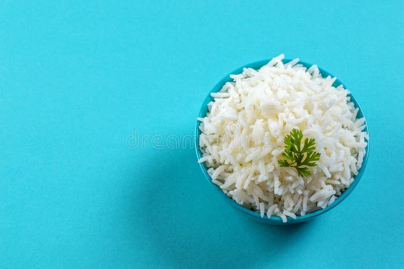 Cooked Plain White Basmati Rice with Corriander in a Blue Bowl on Blue